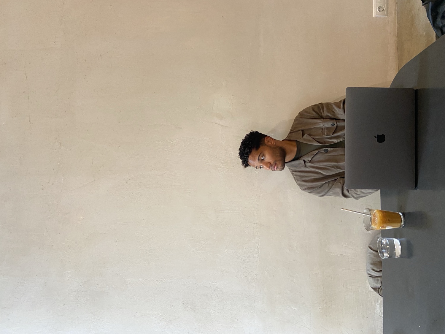 Felix Sonny Ijeh working on a laptop in a café